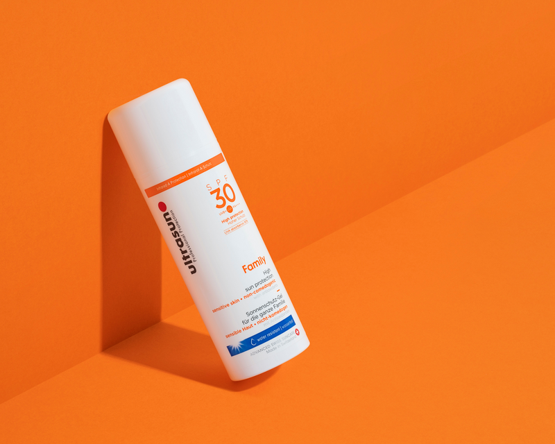 Ultrasun Family SPF30 sun cream bottle on an orange background